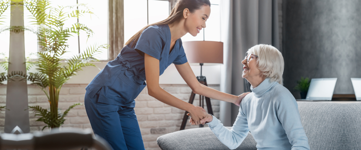 caregiver taking care of elderly woman at home