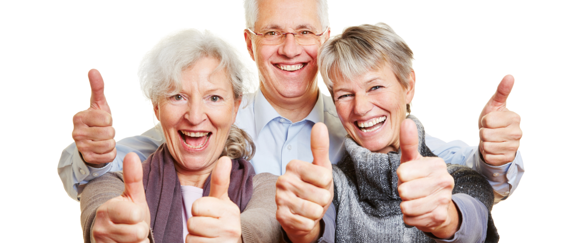 Three happy senior people holding their thumbs up